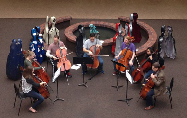 Dr. Benjamin Whitcomb playing Cello in a group with students